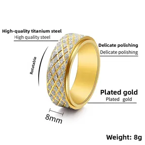 Macro view of 8mm gold titanium rotatable ring showing diamond-cut textured band detail
