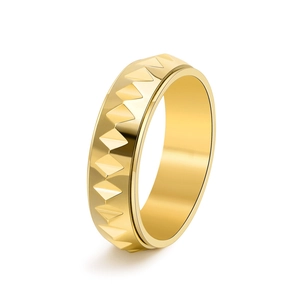 Detailed view of the 3D pyramid faceted texture on a gold stainless steel spinner ring