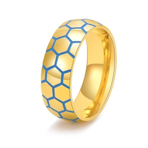 Detail of gold football ring with blue hexagonal pattern showing texture and finish