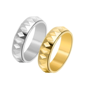 Macro detail of silver and gold stainless steel rings with geometric triangle relief