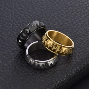 Mens stainless steel spinning rings with punk pyramid studs in black, gold and silver