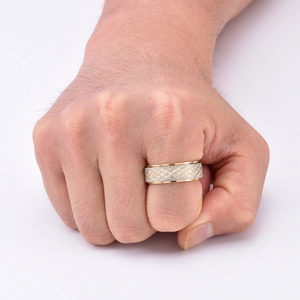 Detail of men's spinning titanium ring with gold edges and silver mesh texture