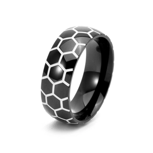 Macro shot of black stainless steel ring with silver honeycomb soccer pattern details