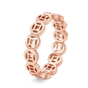 Detail of rose gold hollow coin ring showing polished metal texture and intricate patterns