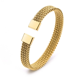 Detail of gold woven mesh bangle featuring polished rectangular end caps on white background