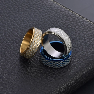 Men's rotating spinner ring with diamond-patterned frosted finish in gold, silver, and blue
