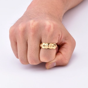 Macro detail of men's faceted gold stainless steel ring with 3D pyramid relief pattern