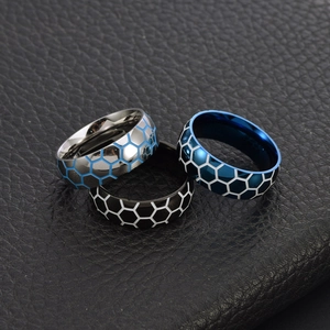 Detailed view of three stainless steel football rings with honeycomb texture on leather