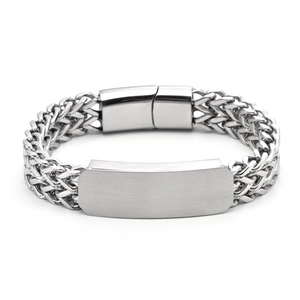 Macro detail of men's silver woven chain bracelet with engravable metal nameplate