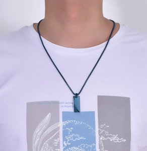 Close-up of a men's navy blue tungsten pendant with geometric cut and sleek bead chain