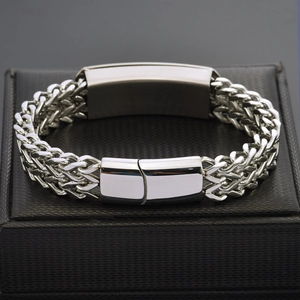 Close-up of men's titanium steel woven bracelet with polished rectangular metal plate