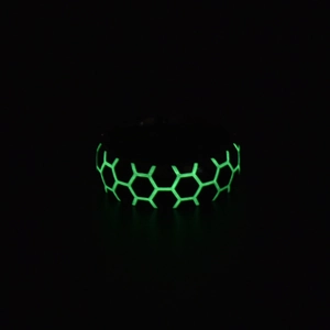 Luminous football ring showing glowing green honeycomb pattern in the dark