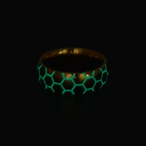 Luminous football ring with green glowing honeycomb pattern on gold stainless steel