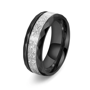 Detail of titanium ring showing black hammered edges and silver rime texture inlay