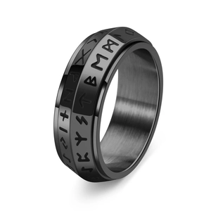 Detailed macro shot of black titanium steel spinning ring with Nordic Viking rune engravings