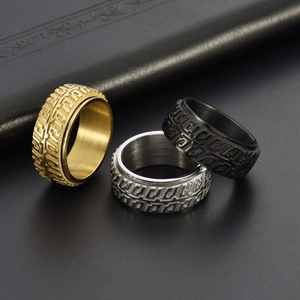 Close-up of three rotating tire pattern rings in gold, silver, and black finishes