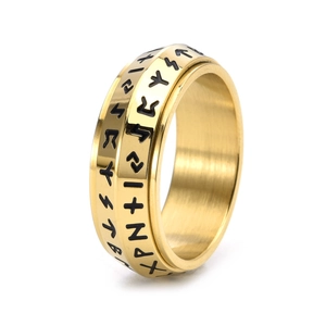 Detailed view of golden Viking rune spinner ring with engraved Elder Futhark symbols