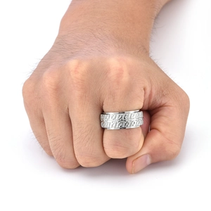 Close-up of silver titanium steel spinning ring with 3D industrial tire tread texture