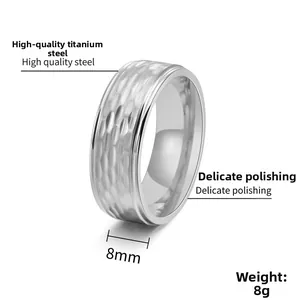 Detail view of 8mm silver hammered titanium steel men ring with polished inner surface