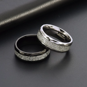 Faceted titanium steel rings with textured silver inlay in black and silver finishes