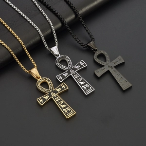 Detailed view of Egyptian Ankh pendants in gold, silver, and black with hieroglyphics