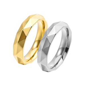 Detailed view of silver and gold geometric rhombic cut rings with polished faceted surfaces