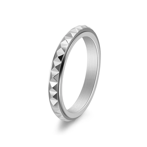 Macro view of rotating silver ring with pyramid studs in a sleek minimalist design