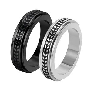 Modern spinning rings in silver and black stainless steel with textured V-groove patterns