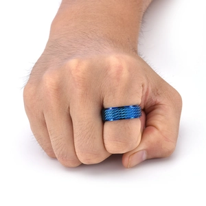 Close-up of blue rotatable stress relief ring with diamond pattern knurled texture