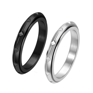 Detailed macro view of geometric faceted textures on black and silver titanium rings