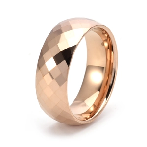 Polished rose gold tungsten ring with geometric faceted diamond cut surface on white background