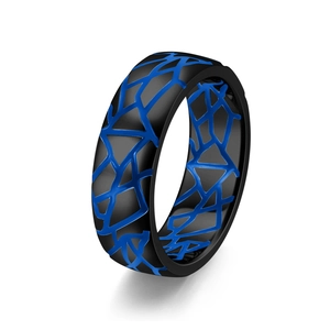 Detail of vintage crackle pattern ring with blue luminous geometric mesh on black metal