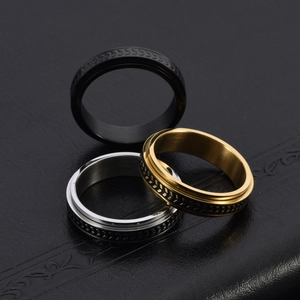 Macro shot of rotatable stainless steel rings with anti-slip olive leaf texture on leather