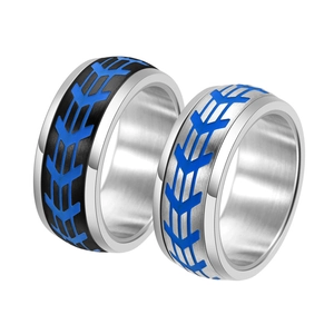 Close-up of industrial titanium steel rings with blue tire tread texture and brushed metal