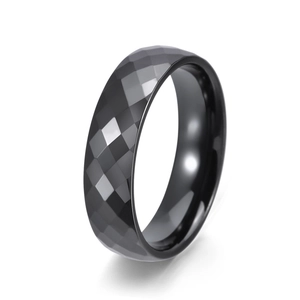 Detailed view of black ceramic ring featuring a faceted geometric surface and polished inner edge