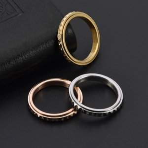 Macro detail of three-piece stackable rings featuring polished pyramid grid patterns