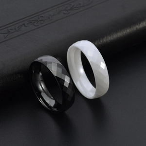 Minimalist black and white faceted ceramic couple rings with diamond-cut polished finish