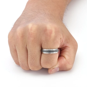 Close-up of polished stainless steel rotating ring with black tire tread pattern