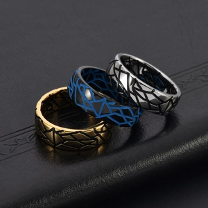 Close-up of vintage titanium steel rings with cracked texture in gold, blue and silver
