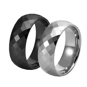 Close-up of black and silver tungsten rings with precision faceted diamond patterns