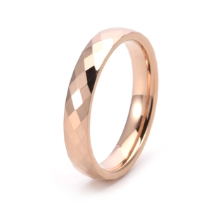 Detail of rose gold tungsten ring with diamond-cut faceted surface and polished inner band