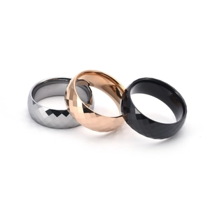 Close-up of three-color tungsten steel rings with geometric diamond cut surfaces