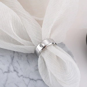 Polished titanium steel ring with a distinctive punk spike rivet on a smooth band