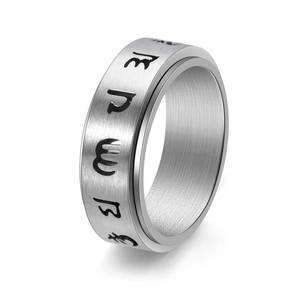 Macro detail of silver rotatable mantra ring with brushed finish and engraved symbols