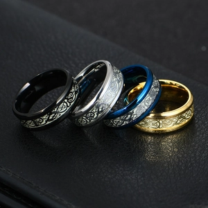 Macro detail of men's titanium steel rings with glowing dragon pattern in four colors