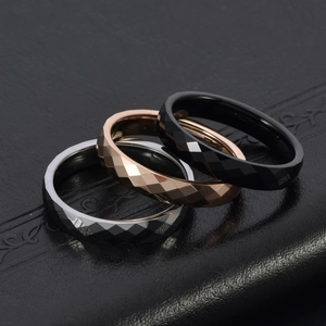 Macro shot of geometric diamond cut tungsten steel rings in silver, rose gold and black