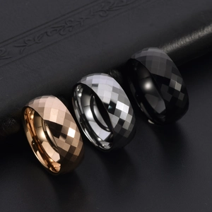 Macro detail of tungsten steel rings with geometric diamond cut texture in three colors