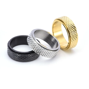Rotating stainless steel rings with diamond texture in black, silver, and gold colors