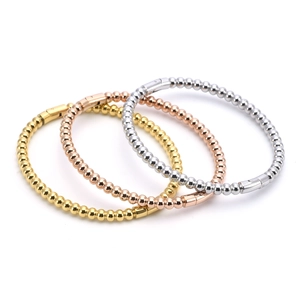 Stack of gold, rose gold and silver beaded bangles with high polish finish and clasps