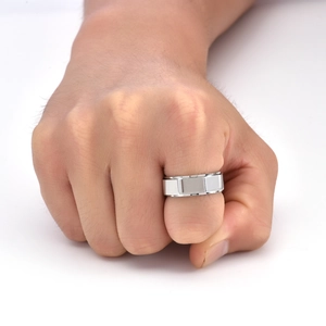 Detail view of men's rotatable silver steel ring with geometric octagonal patterns